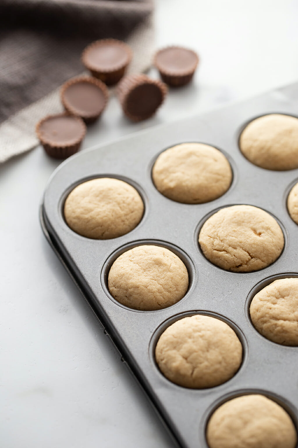Peanut Butter Cup Cookie dougn in a muffin tin before cooking