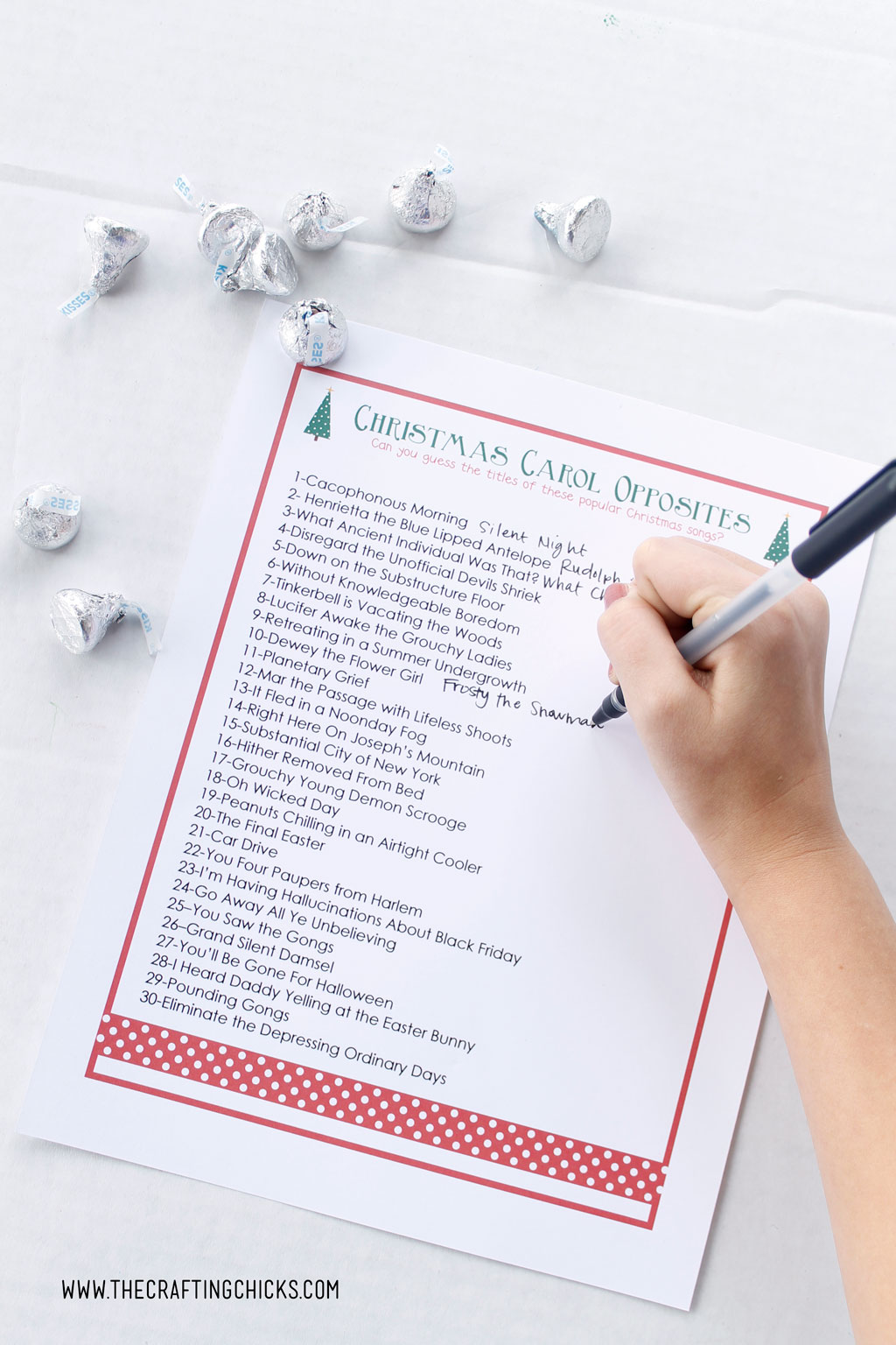 Christmas Carol Opposites free printable with hand writing answer in black pen.