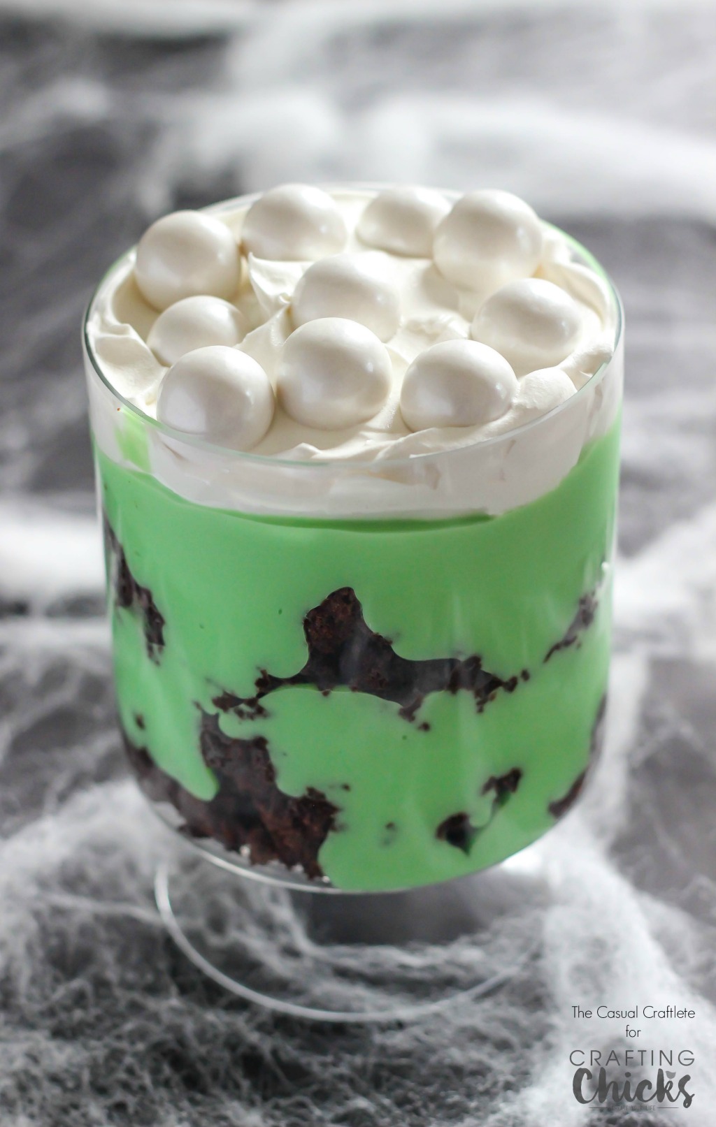 Witch's Brew Dessert Trifle is made with layers of brownies, pudding, and whipped topping. This easy recipe is perfect for a Halloween party!