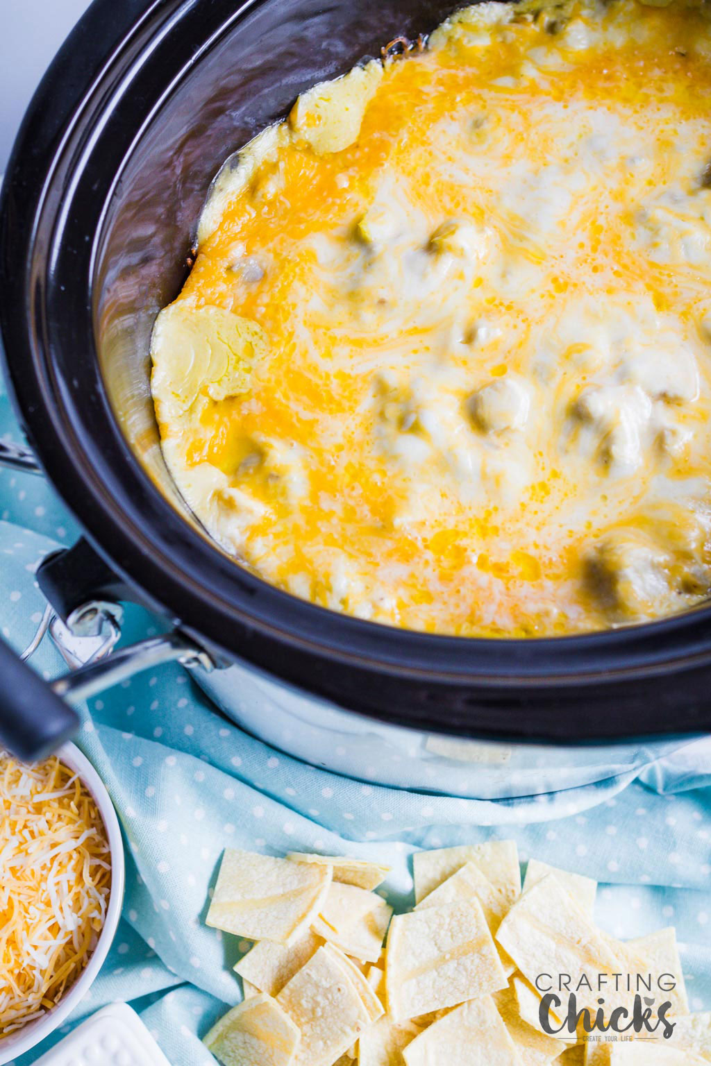 Crockpot Chicken Enchilada Casserole is easy but full of flavor. With green chilies and lots of cheese, this is a crowd pleaser that can feed a crowd.