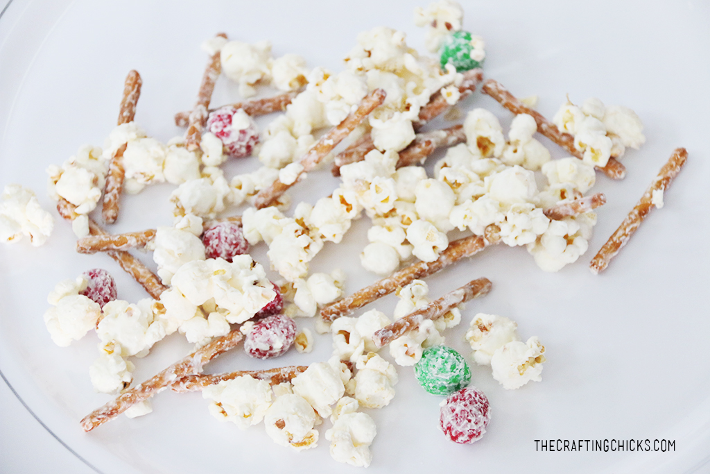 White chocolate covered popcorn, pretzels, and peanut M&M's combine for this Santa Popcorn Snack Mix.