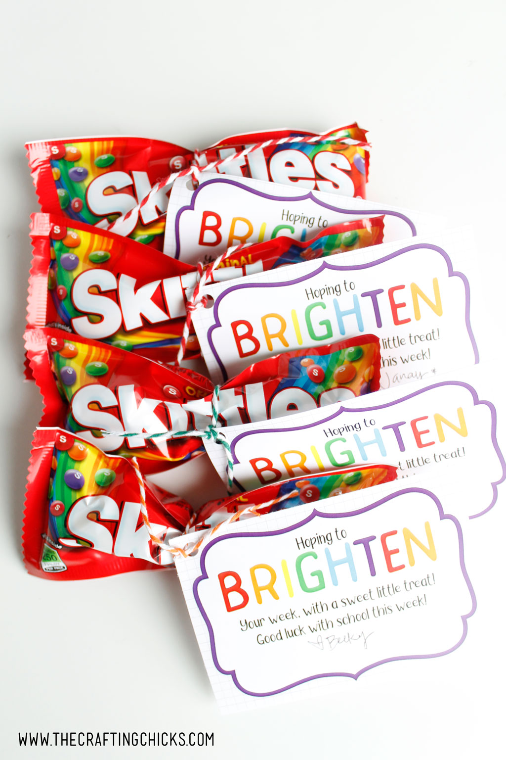 Brighten your day gift tags tied to bags of Skittles as a gift idea.