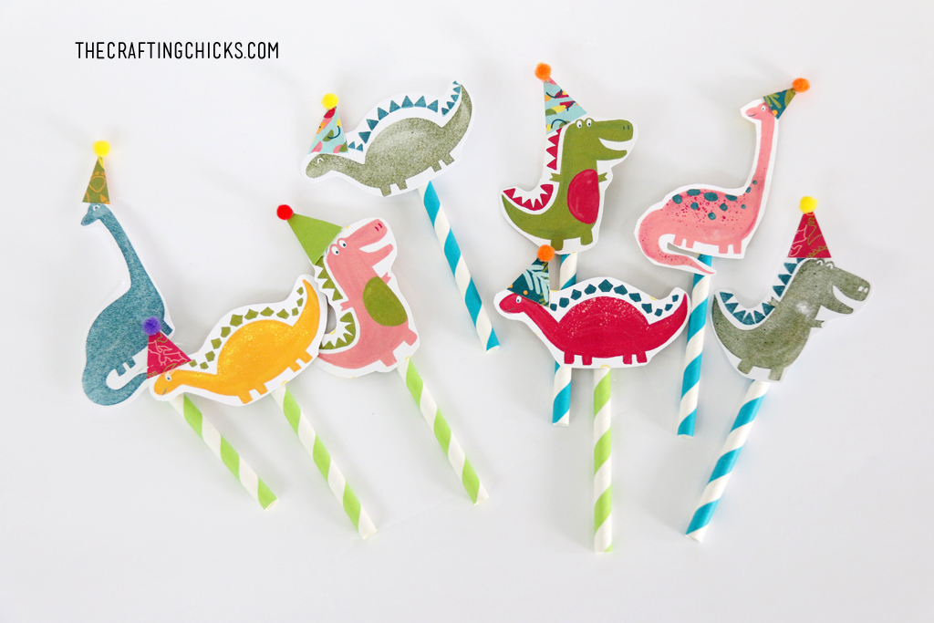 Hand stamped Dinosaurs on paper straws stuck in cupcakes. Cute Dinosaur Cupcake toppers.