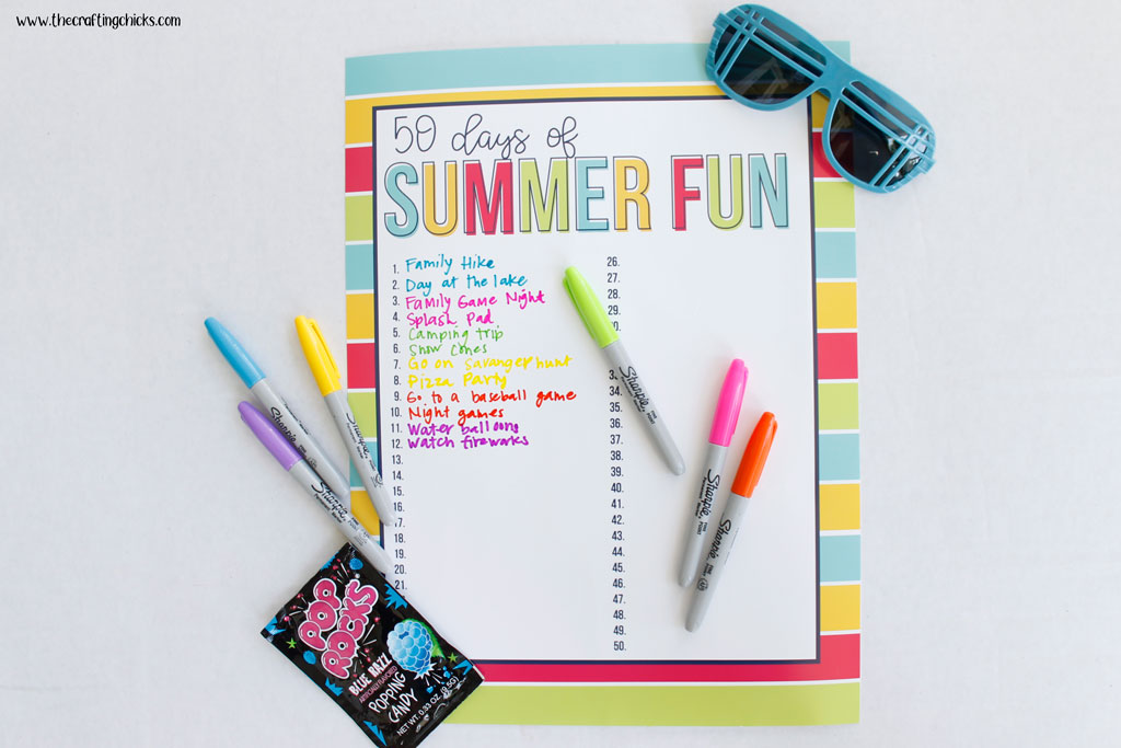 Markers and sunglasses around a poster sized printable 50 Days of Summer Fun chart