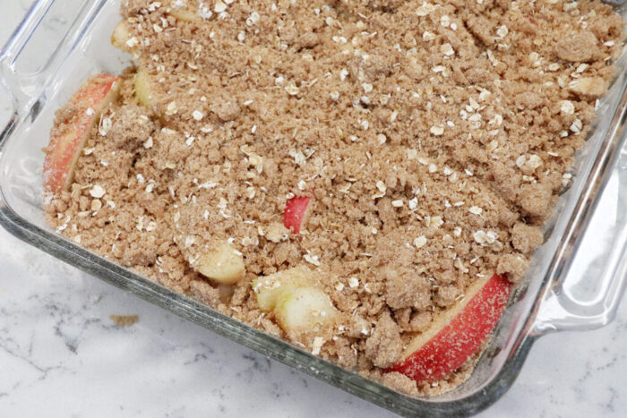 Sliced Honey Crisp apples covered with cinnamon mixture for apple crisp.