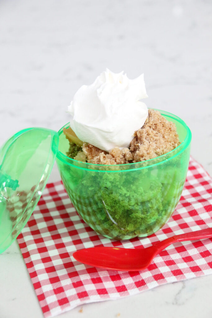 Baked apple crisp with golden brown oat topping in a baking dish.