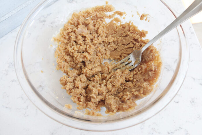 Apple Crumble topping mixed in a bowl with a fork.