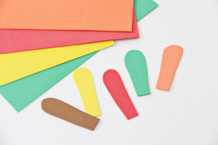 Thanksgiving Turkey craft with brown craft foam face and crayons as feathers.