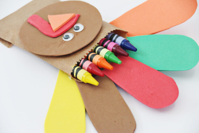 Thanksgiving Turkey craft with brown craft foam face and crayons as feathers.